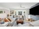 Comfortable living room features large sectional couch, big screen TV, and a bay window overlooking a manicured lawn at 3 Lauden Blvd, Isle of Palms, SC 29451