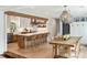 Open concept kitchen and dining room feature bright light, wood accents and breakfast bar seating at 3 Lauden Blvd, Isle of Palms, SC 29451