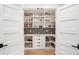 Well-organized pantry with ample shelving, white cabinets, and stylish storage containers at 3 Lauden Blvd, Isle of Palms, SC 29451