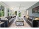 Bright sunroom with multiple windows providing a view of the lush landscaping at 3 Lauden Blvd, Isle of Palms, SC 29451