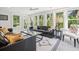 Bright sunroom with multiple windows providing a view of the lush landscaping at 3 Lauden Blvd, Isle of Palms, SC 29451