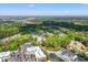 Expansive aerial view of townhomes with lush landscaping, community pond, and proximity to nature preserve at 3010 Emma Ln, Mount Pleasant, SC 29466