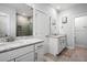 Bright bathroom with double vanity, granite countertop, white cabinetry, and framed mirrors, creating a refreshing and functional space at 3010 Emma Ln, Mount Pleasant, SC 29466