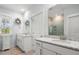 Bright bathroom with double vanity, granite countertop, white cabinetry, and framed mirrors, creating a refreshing and functional space at 3010 Emma Ln, Mount Pleasant, SC 29466
