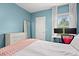 Comfortable bedroom features an accent wall, ceiling fan, and a window with natural light at 3010 Emma Ln, Mount Pleasant, SC 29466