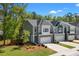 Beautiful exterior view of gray townhomes, lush green grass, professional landscaping and long private driveways at 3010 Emma Ln, Mount Pleasant, SC 29466