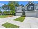 Gray two-story townhomes with private driveways, two-car garages, professionally landscaped front yards at 3010 Emma Ln, Mount Pleasant, SC 29466