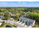 Beautiful view of townhomes with well-manicured lawns, palm trees, and a tranquil pond at 3010 Emma Ln, Mount Pleasant, SC 29466