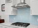 Kitchen features white cabinets, stainless hood, gas range, and backsplash at 3010 Emma Ln, Mount Pleasant, SC 29466