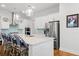 Kitchen island featuring stainless steel appliances, barstool seating, and modern lighting at 3010 Emma Ln, Mount Pleasant, SC 29466