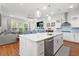 Open concept kitchen features an island with seating, stainless appliances, and flows into the living area at 3010 Emma Ln, Mount Pleasant, SC 29466