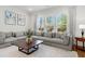 Bright and airy living room featuring a large sectional sofa, hardwood floors, and a large window at 3010 Emma Ln, Mount Pleasant, SC 29466