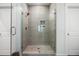 Modern walk-in shower featuring neutral tile, glass door, and built-in shelves, creating a spa-like experience at 3010 Emma Ln, Mount Pleasant, SC 29466