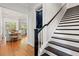 Bright foyer with hardwood floors, staircase with white risers and dark wood treads, adjacent to dining area and living area at 3010 Emma Ln, Mount Pleasant, SC 29466