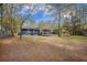 Inviting backyard featuring a well-maintained lawn and a charming deck area, ideal for outdoor relaxation and entertainment at 306 Teakwood Dr, Walterboro, SC 29488