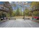 Large deck overlooking a spacious yard with swing benches and serene landscaping at 306 Teakwood Dr, Walterboro, SC 29488