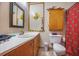 Cozy bathroom with wooden cabinets, neutral walls, and a classic mirror, creating a practical and functional space at 306 Teakwood Dr, Walterboro, SC 29488