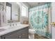 A bathroom with a toilet, a vanity, and a decorative shower curtain at 306 Teakwood Dr, Walterboro, SC 29488