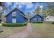 Inviting home exterior with a well-manicured lawn, a brick walkway, and a lovely front entrance at 306 Teakwood Dr, Walterboro, SC 29488