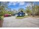 A blue two-story house with a large front yard, flowering bushes, and concrete driveway at 306 Teakwood Dr, Walterboro, SC 29488