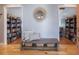 A hallway with a decorative mirror and bench leading to rooms with built-in bookshelves at 306 Teakwood Dr, Walterboro, SC 29488