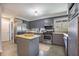 The kitchen boasts stainless steel appliances, tile floors and a breakfast bar at 306 Teakwood Dr, Walterboro, SC 29488