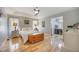 A large bedroom with hardwood floors, neutral paint and trim and adjoining bath and vanity at 306 Teakwood Dr, Walterboro, SC 29488