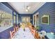 Charming sunroom featuring ample seating, a ceiling fan, and access to the outdoors, perfect for relaxation and entertaining at 306 Teakwood Dr, Walterboro, SC 29488