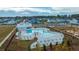 Aerial view featuring a community pool, splashpad and playground, complemented by neatly arranged houses at 3466 Yarmouth Dr, Mount Pleasant, SC 29466