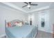 Inviting bedroom with tray ceilings, ceiling fan and natural light from sheer curtained windows at 3466 Yarmouth Dr, Mount Pleasant, SC 29466
