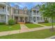Charming multi-colored two-story townhomes with inviting front porches and well manicured lawns at 3466 Yarmouth Dr, Mount Pleasant, SC 29466