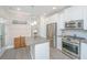 Stylish kitchen boasts white cabinets, granite countertops, stainless steel appliances, and wood accent wall at 3466 Yarmouth Dr, Mount Pleasant, SC 29466