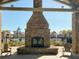 Outdoor fireplace with seating and views of the pool area, creating a cozy and inviting ambiance at 3466 Yarmouth Dr, Mount Pleasant, SC 29466
