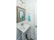 Powder room featuring a pedestal sink with brushed nickel faucet and a framed mirror at 3466 Yarmouth Dr, Mount Pleasant, SC 29466