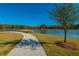 Scenic walking path curves around a tranquil lake with lush greenery and mature trees at 3466 Yarmouth Dr, Mount Pleasant, SC 29466