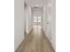 Bright hallway featuring neutral walls, white trim, and warm wood-look flooring at 347 Wappoo Trace Ln, Summerville, SC 29486