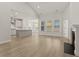 Bright and airy living room featuring a fireplace, open floor plan, and luxury vinyl plank flooring at 347 Wappoo Trace Ln, Summerville, SC 29486