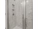 Modern shower featuring marble-look tile, glass door, and recessed niche at 347 Wappoo Trace Ln, Summerville, SC 29486