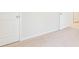 Bedroom with neutral carpet and white walls and trim, complemented by two doors, conveying a clean design at 348 Dickerson Ln, Lincolnville, SC 29485