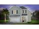 Charming two-story home featuring gray siding, a front-entry garage, and a well-manicured lawn at 348 Dickerson Ln, Lincolnville, SC 29485