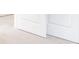 Close up on a carpeted hallway with baseboards and white doors, conveying a clean and simple design at 348 Dickerson Ln, Lincolnville, SC 29485