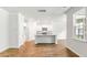 Modern kitchen featuring white cabinets, granite countertops, stainless appliances, and open to living room at 348 Dickerson Ln, Lincolnville, SC 29485