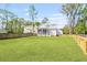 Expansive backyard with lush green grass, surrounded by a tall wooden fence for privacy at 4155 Jean Laffite Rd, Hollywood, SC 29449