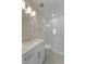 Modern bathroom with white cabinets, elegant light fixtures, and a glass shower at 4155 Jean Laffite Rd, Hollywood, SC 29449