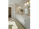 Elegant bathroom features double vanity with white cabinets, gold fixtures and ample counter space at 4155 Jean Laffite Rd, Hollywood, SC 29449