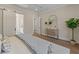 Cozy bedroom featuring a sliding door to the ensuite bathroom, wood floors, and a dresser at 4155 Jean Laffite Rd, Hollywood, SC 29449