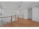 Spacious bonus room features wood floors and a staircase with white spindles at 4155 Jean Laffite Rd, Hollywood, SC 29449
