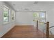 Bright bonus room with plenty of windows, a ceiling fan, and hardwood flooring at 4155 Jean Laffite Rd, Hollywood, SC 29449