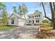 Beautifully landscaped front yard with an inviting white home and detached garage at 4155 Jean Laffite Rd, Hollywood, SC 29449