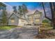 Beautiful two-story home with charming white siding, a spacious garage, and a gravel driveway at 4155 Jean Laffite Rd, Hollywood, SC 29449